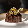 Elegant chocolate dessert with gold leaf decoration✨