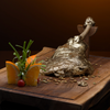 Roast meat with bone in Gold Leaf on a wooden tray