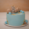 Blue celebration cake decorated with edible gold leaf